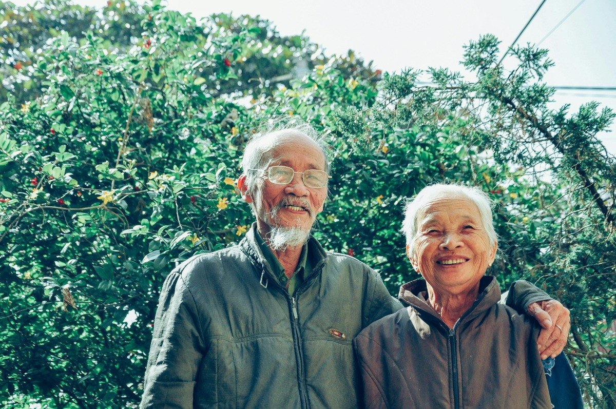 Old couple smiling off into the distance
